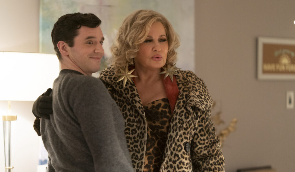 Single All The Way (L-R).   Michael Urie as Peter,  Jennifer Coolidge as Aunt Sandy, in Single All The Way. Cr. Philippe Bosse/Netflix © 2021